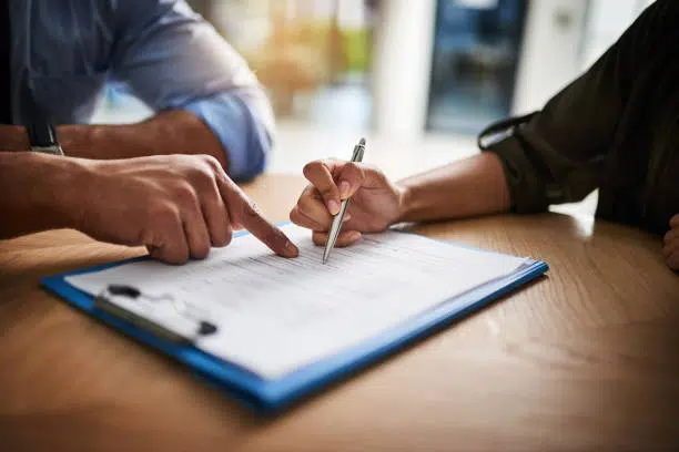 Patient is filling in her medical insurance information in a chiropractic clinic