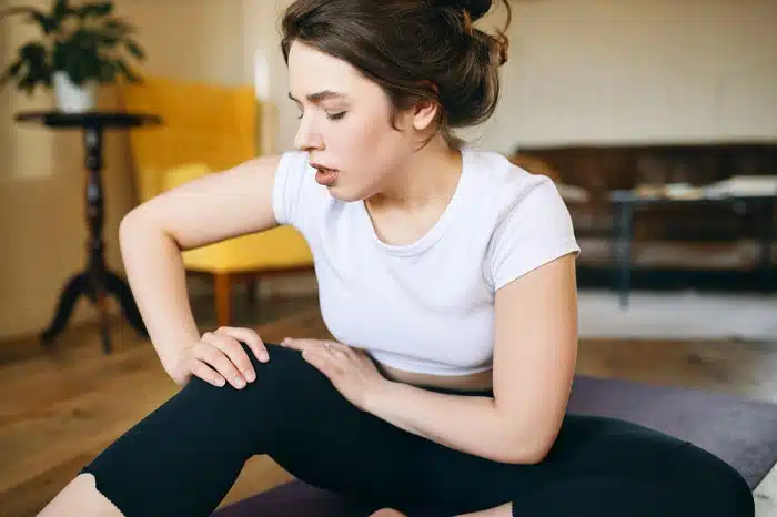 https://www.knoxvillespineandsports.com/wp-content/uploads/2023/02/portrait-of-a-girl-doing-home-pain-management-because-sport-injury-feeling-pain.jpg.webp