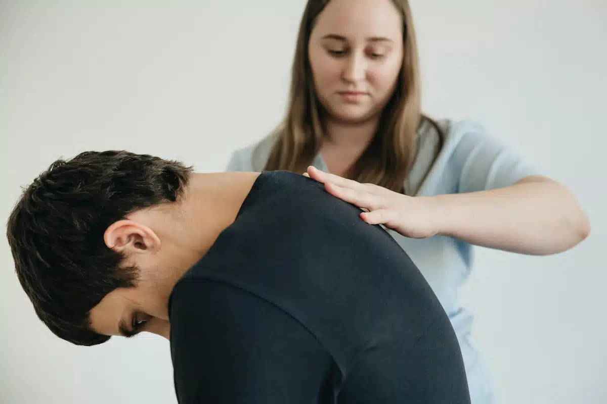 Physiotherapist Helping a Patient Exercise His Back
