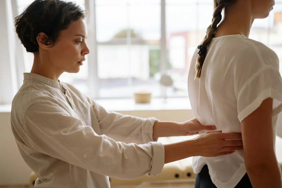 Physiotherapist Touching Womans Back